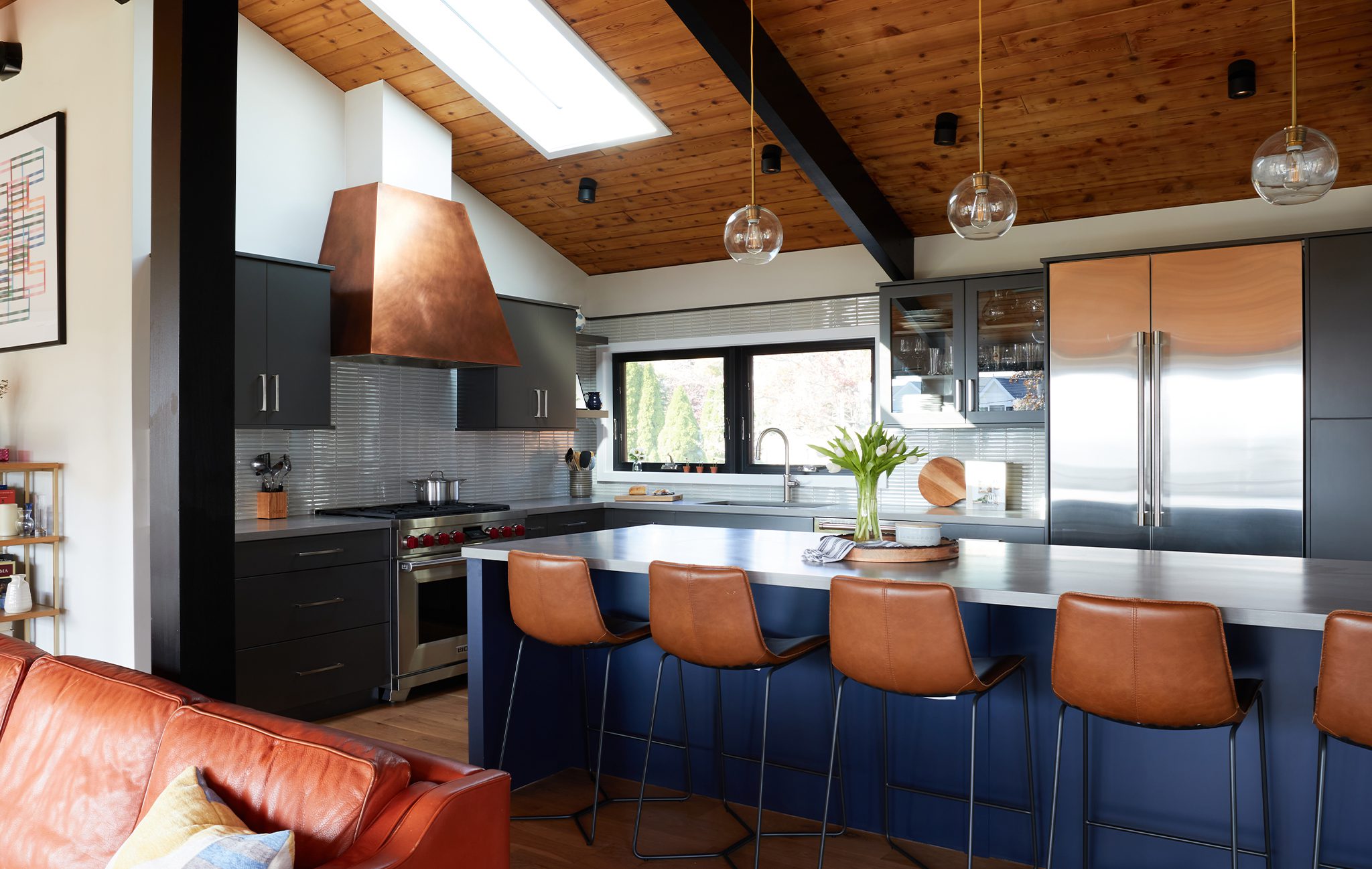 midcentury modern kitchen with warm woods and sleek industrial details.